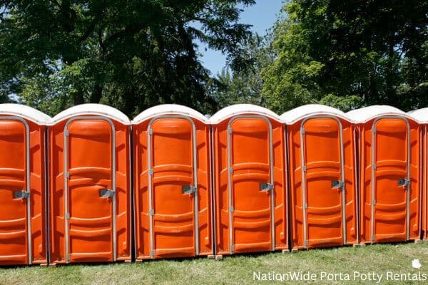 a lineup of clean and well-maintained portable loos for workers in East Helena, MT